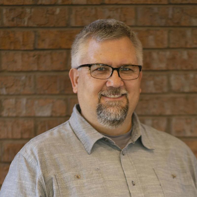 Kevin McGahan in front of a brick wall